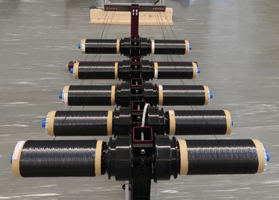 Fibre spools for textile UD tape production